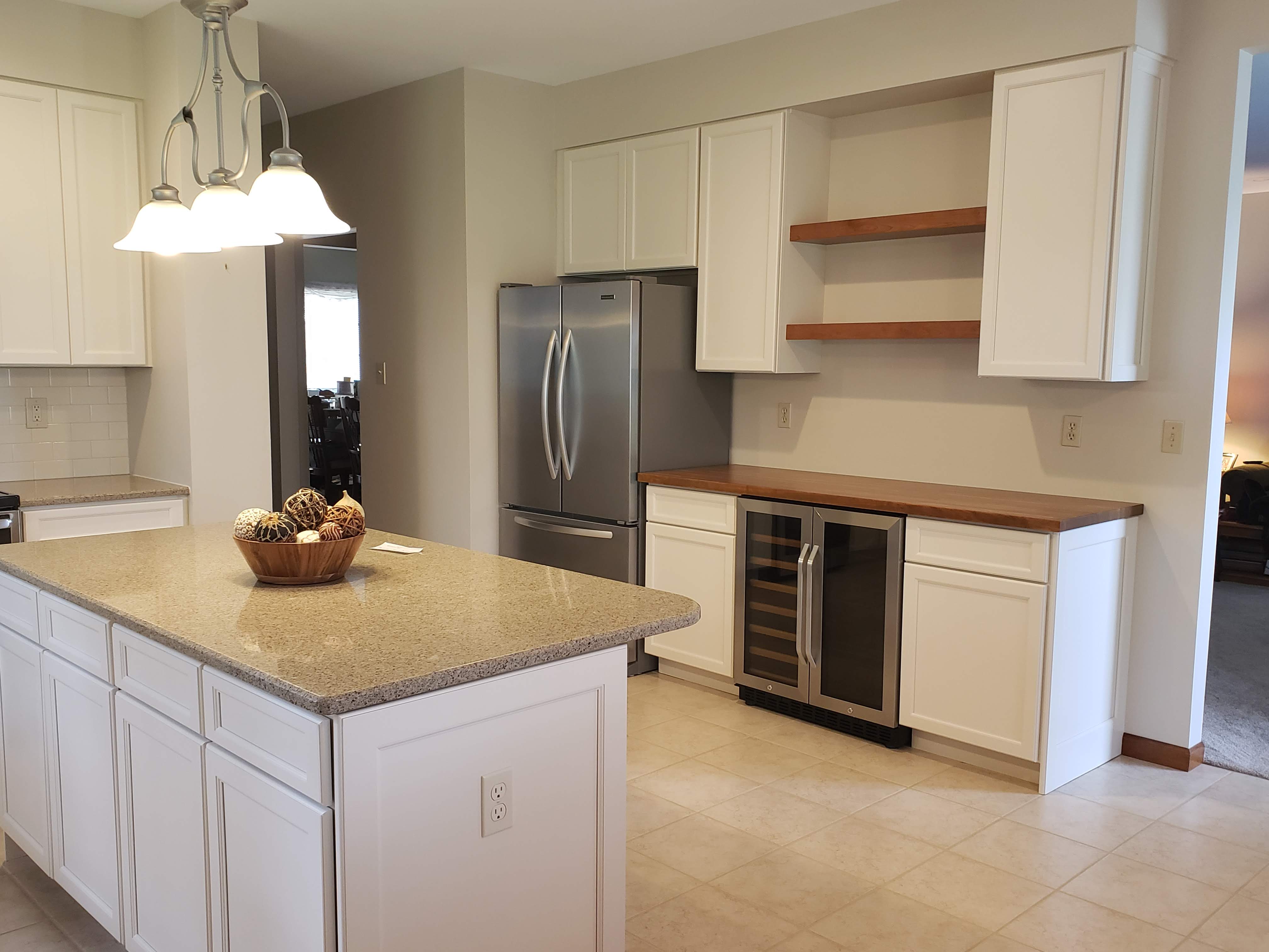 Photo of desk cabinet area converted to beverage center with floating shelves